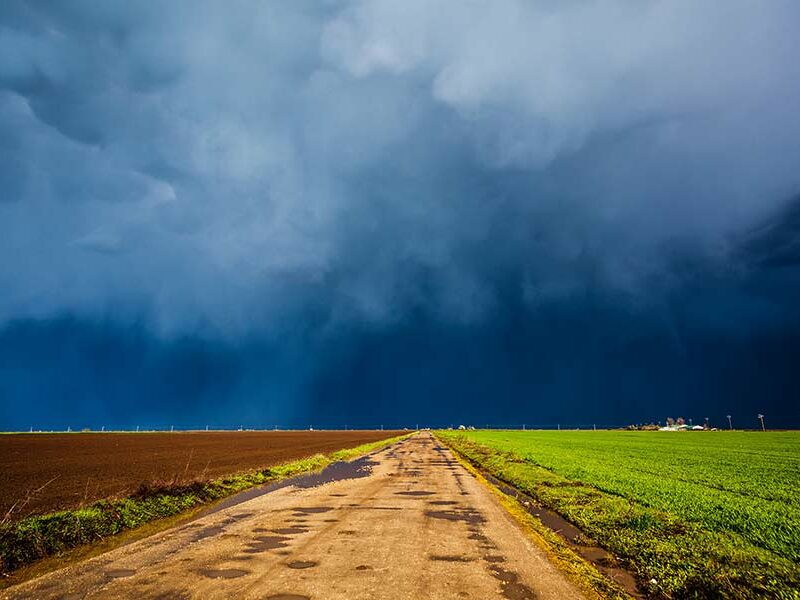 Storm-clouds-over-dirt-road