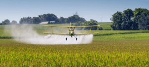 crop duster spraying on farm